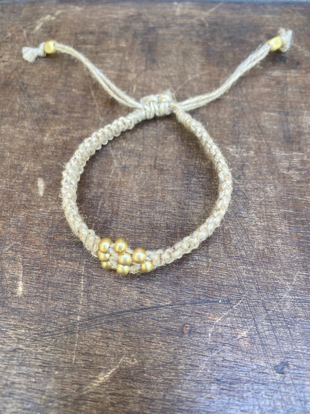 Jute bracelet with gold bead design